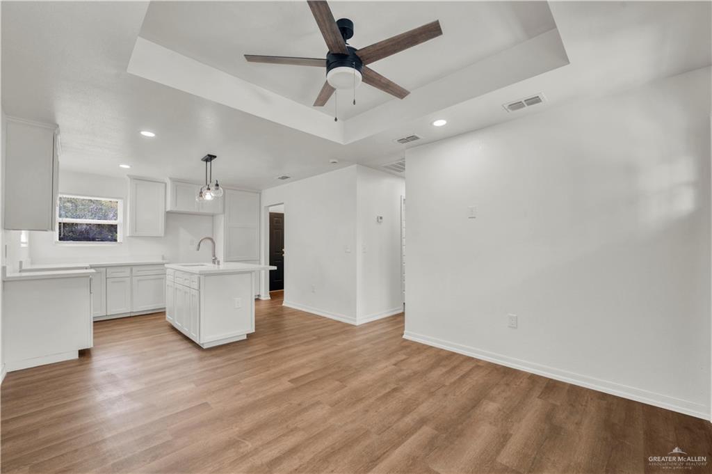 670 West Durham Avenue Raymondville, TX 78580 - Photo 3 of 13 a view of open kitchen with white cabinets and refrigerator