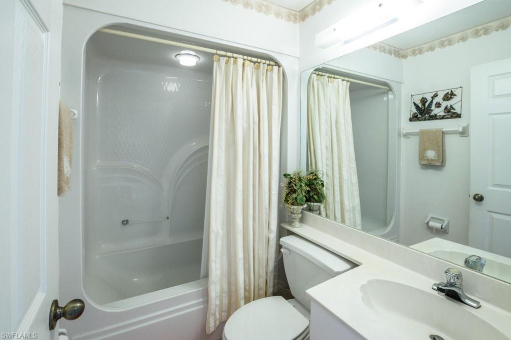 448 Gabriel Circle, Unit 3302 Naples, FL 34104 - Photo 17 of 32 a bathroom with a sink toilet and shower