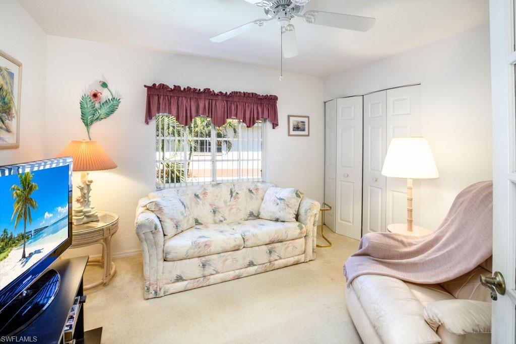 448 Gabriel Circle, Unit 3302 Naples, FL 34104 - Photo 18 of 32 a living room with furniture and a flat screen tv