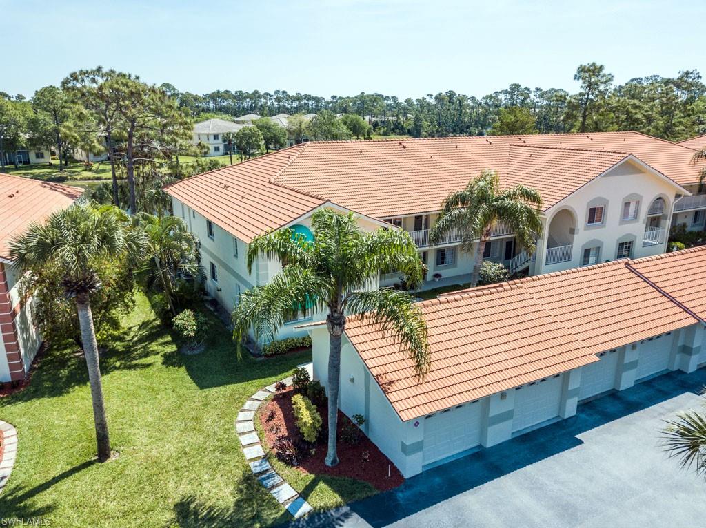 448 Gabriel Circle, Unit 3302 Naples, FL 34104 - Photo 2 of 32 a view of a house with pool and a yard