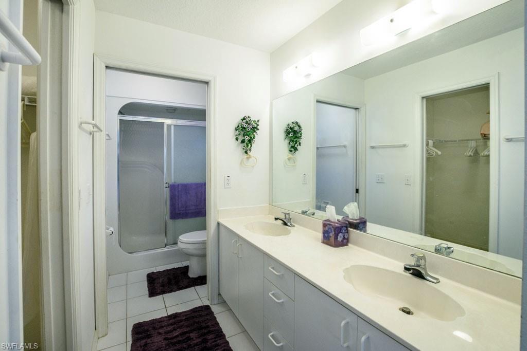 448 Gabriel Circle, Unit 3302 Naples, FL 34104 - Photo 21 of 32 a bathroom with a double vanity sink mirror and double