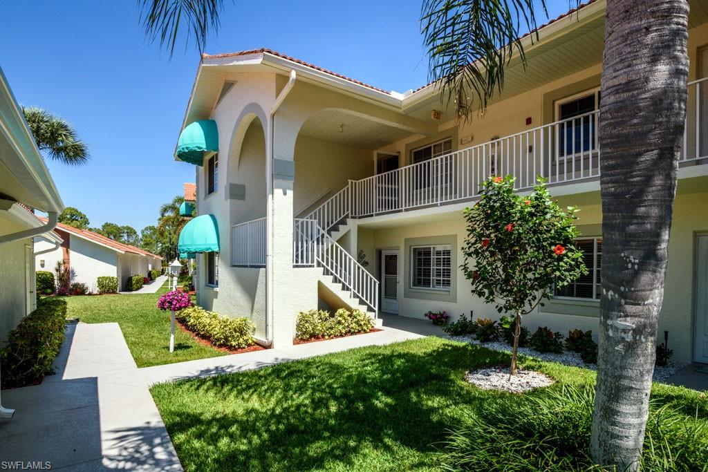 448 Gabriel Circle, Unit 3302 Naples, FL 34104 - Photo 22 of 32 a front view of house with yard and green space