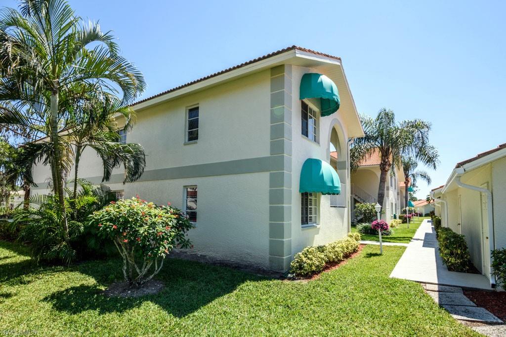 448 Gabriel Circle, Unit 3302 Naples, FL 34104 - Photo 23 of 32 a backyard of a house with lots of green space