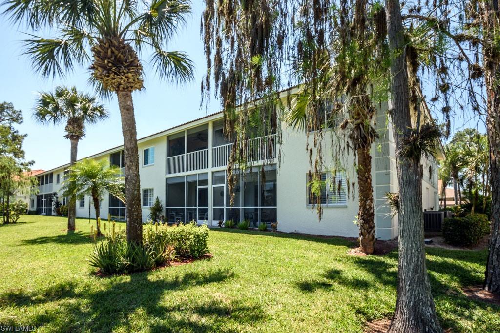 448 Gabriel Circle, Unit 3302 Naples, FL 34104 - Photo 26 of 32 a front view of a house with garden