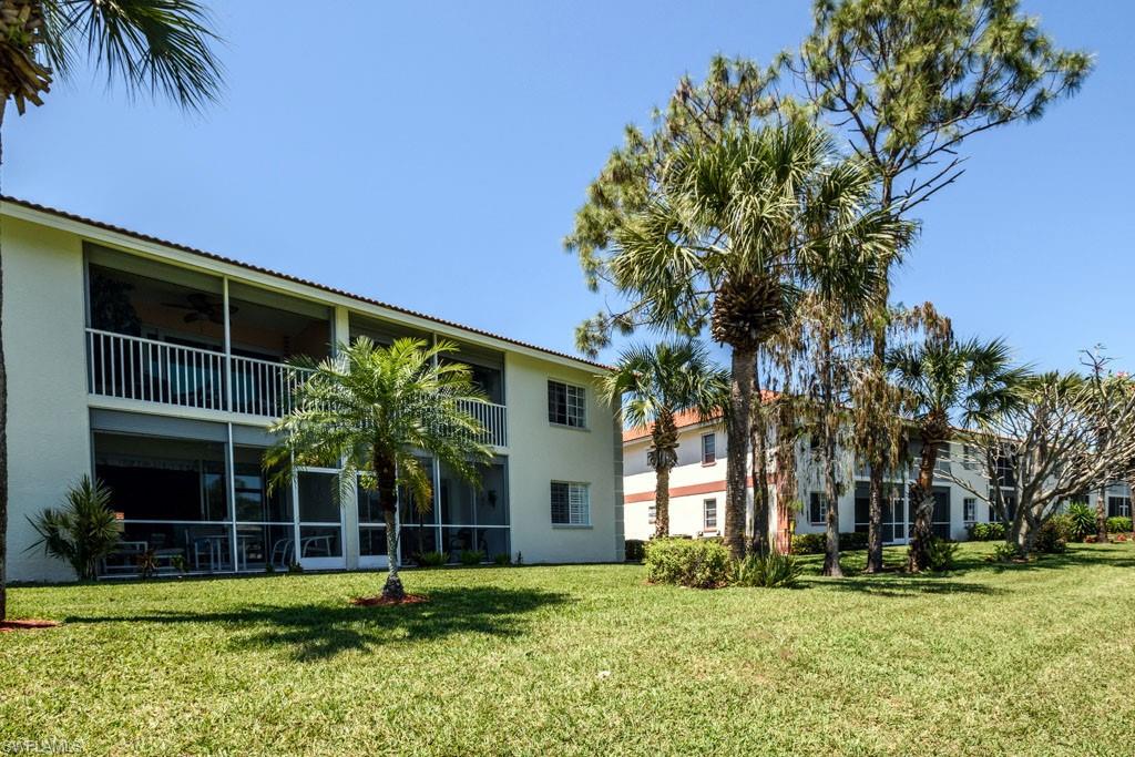 448 Gabriel Circle, Unit 3302 Naples, FL 34104 - Photo 27 of 32 front view of a house with a yard