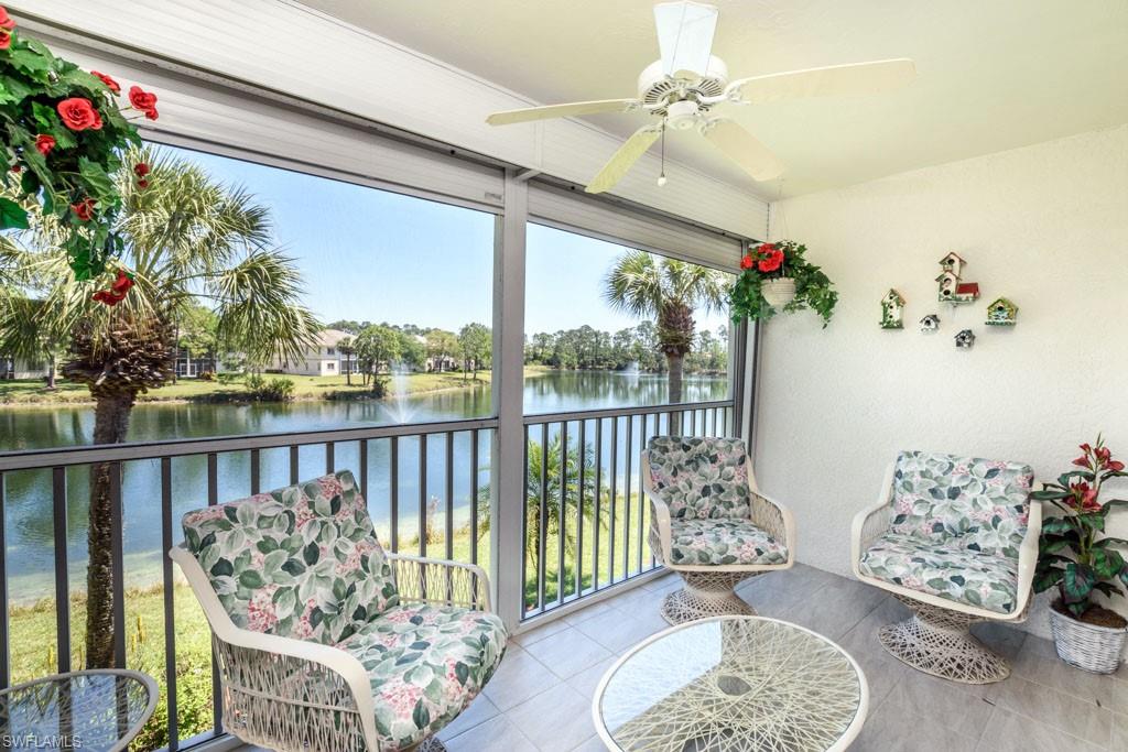 448 Gabriel Circle, Unit 3302 Naples, FL 34104 - Photo 3 of 32 a living room filled with furniture and a floor to ceiling window
