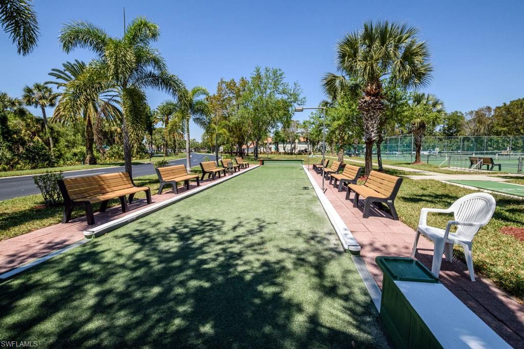 448 Gabriel Circle, Unit 3302 Naples, FL 34104 - Photo 31 of 32 a view of a lake with couches chairs and a yard