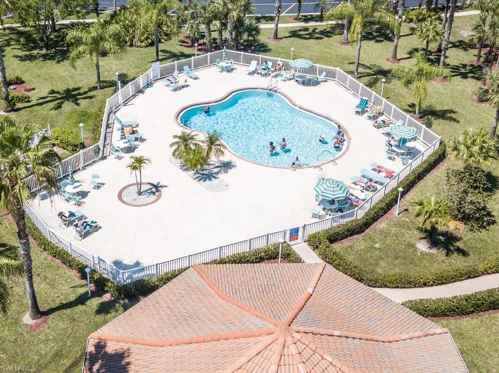 448 Gabriel Circle, Unit 3302 Naples, FL 34104 - Photo 32 of 32 an aerial view of a swimming pool with a yard and lake view