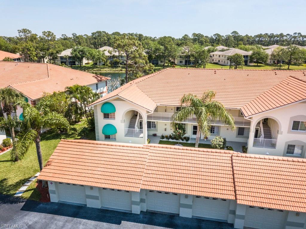 448 Gabriel Circle, Unit 3302 Naples, FL 34104 - Photo 6 of 32 a view of a white house with a yard