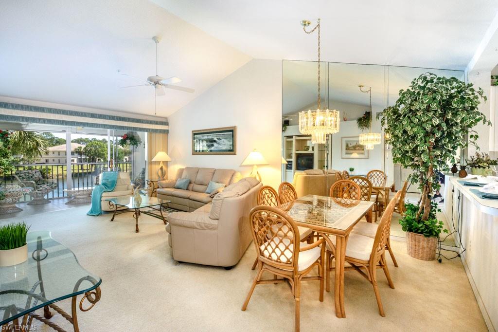 448 Gabriel Circle, Unit 3302 Naples, FL 34104 - Photo 7 of 32 a living room with furniture and a chandelier