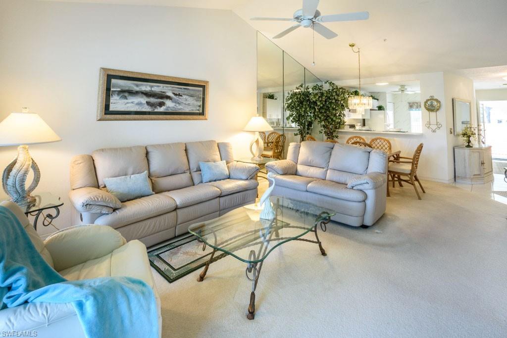 448 Gabriel Circle, Unit 3302 Naples, FL 34104 - Photo 9 of 32 a living room with furniture and a large window