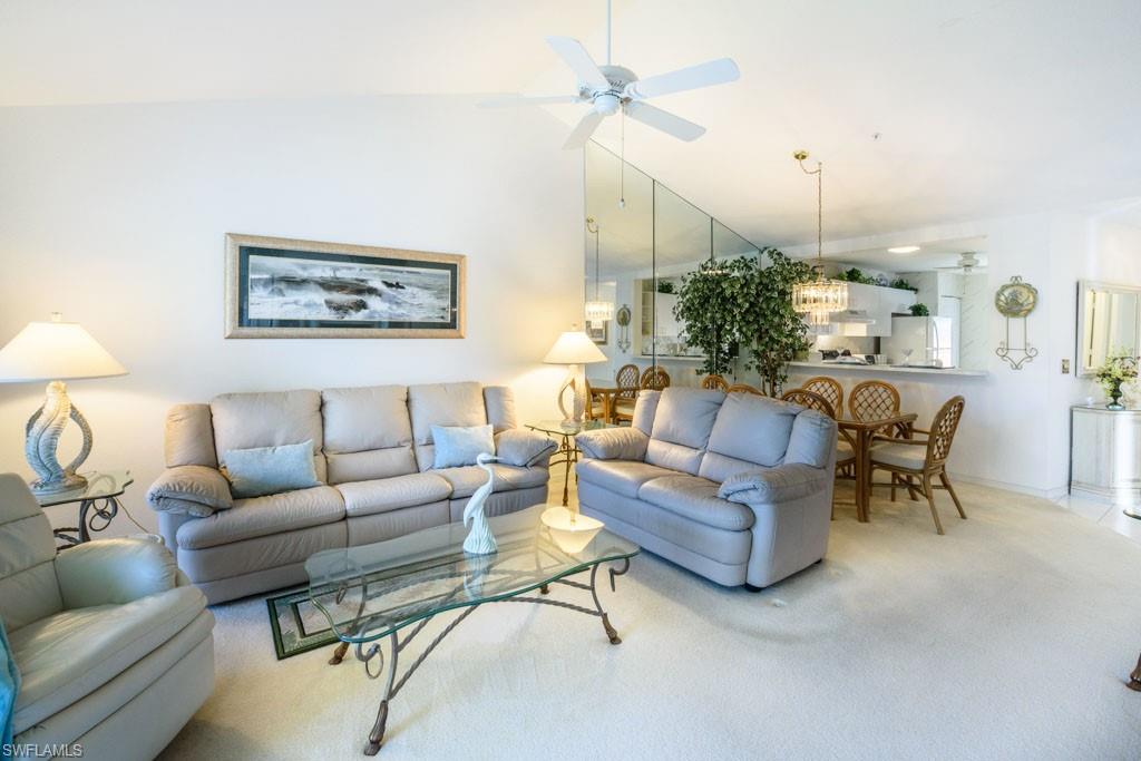 448 Gabriel Circle, Unit 3302 Naples, FL 34104 - Photo 10 of 32 a living room with furniture and a chandelier