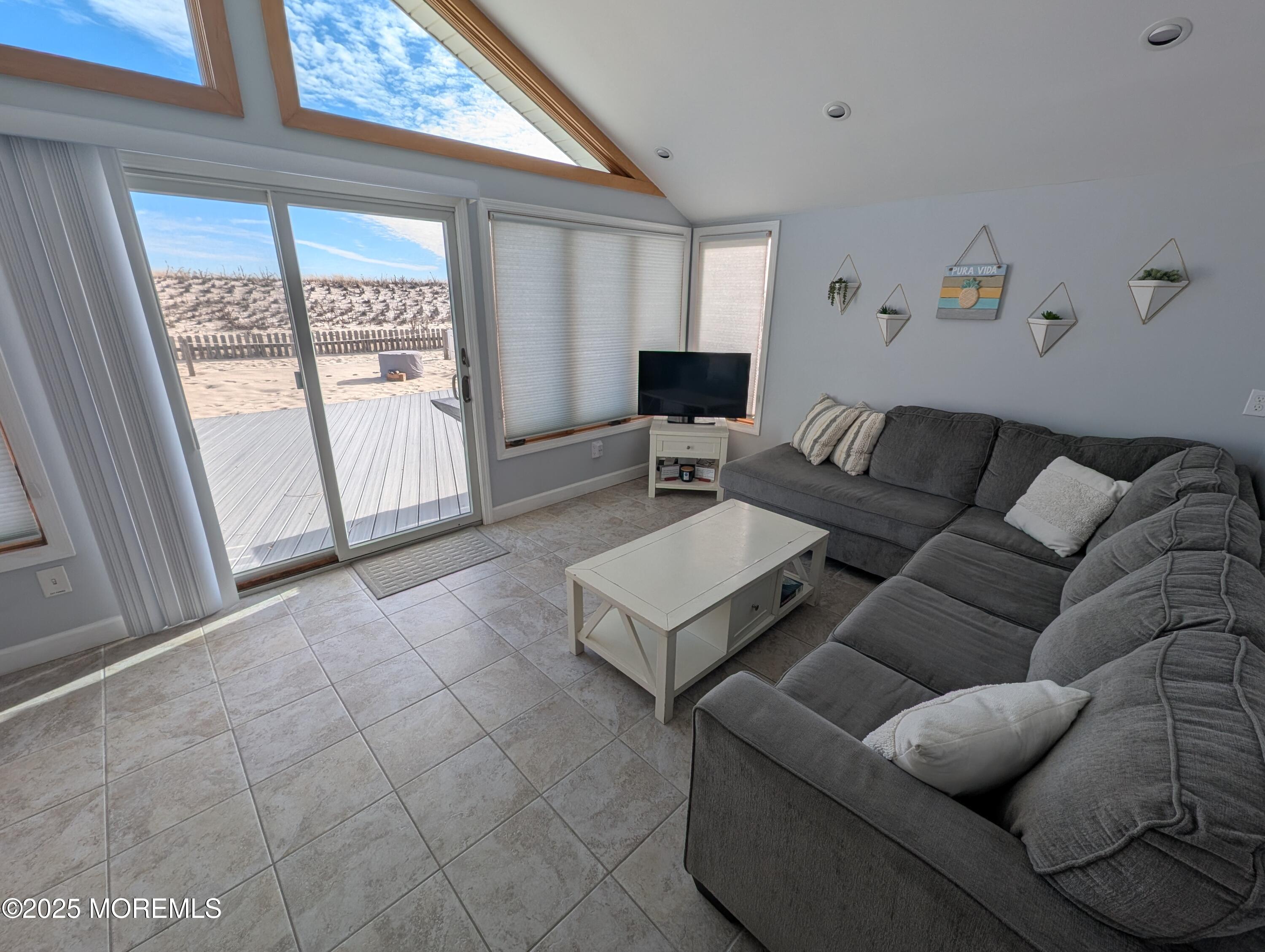 3170 Ocean Road Lavallette, NJ 08735 - Photo 3 of 13 a living room with furniture and a floor to ceiling window