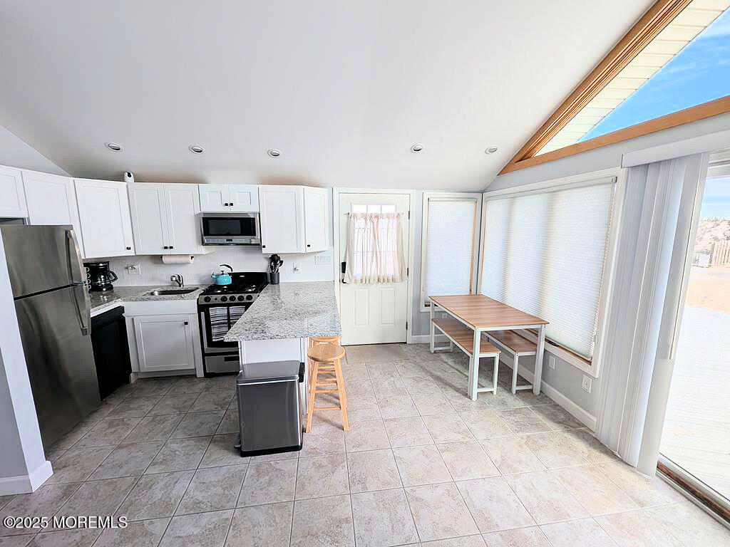 3170 Ocean Road Lavallette, NJ 08735 - Photo 4 of 13 a kitchen with granite countertop a refrigerator stove top oven and sink