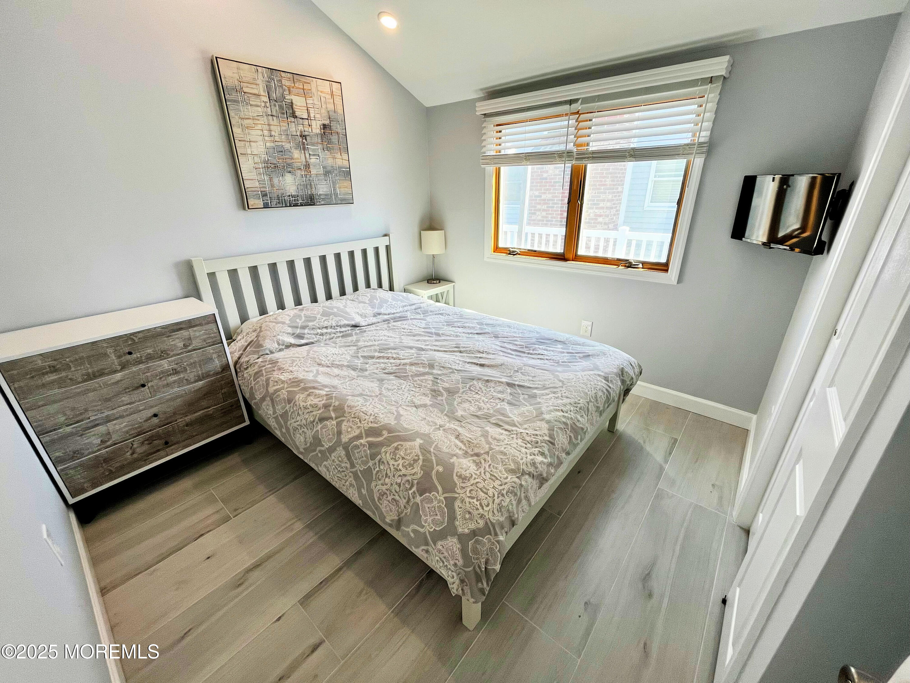 3170 Ocean Road Lavallette, NJ 08735 - Photo 7 of 13 a bed sitting in a bedroom next to a window