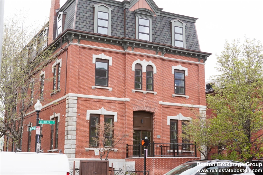 409 Dudley Street, Unit 1 Boston, MA 02119 - Photo 6 of 6 a front view of a residential apartment building with a yard