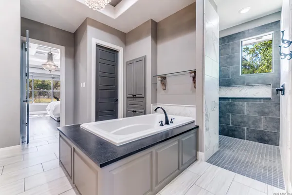 a kitchen with granite countertop a sink cabinets and window