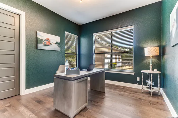 a bathroom with a granite countertop toilet sink and mirror