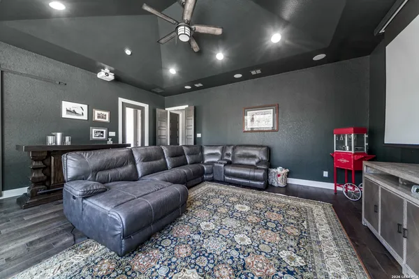 a bedroom with furniture and a flat screen tv