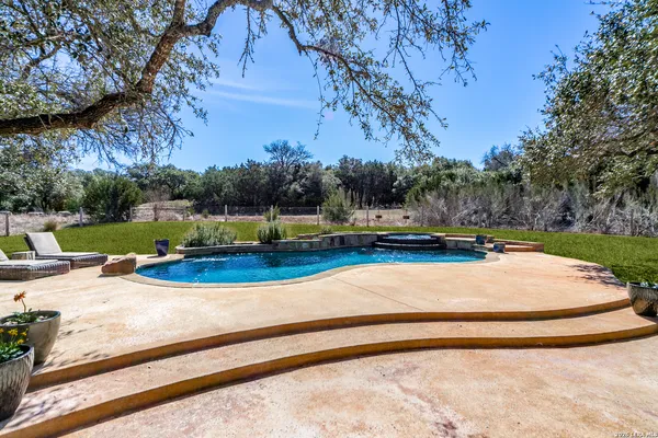 a view of a swimming pool with a yard