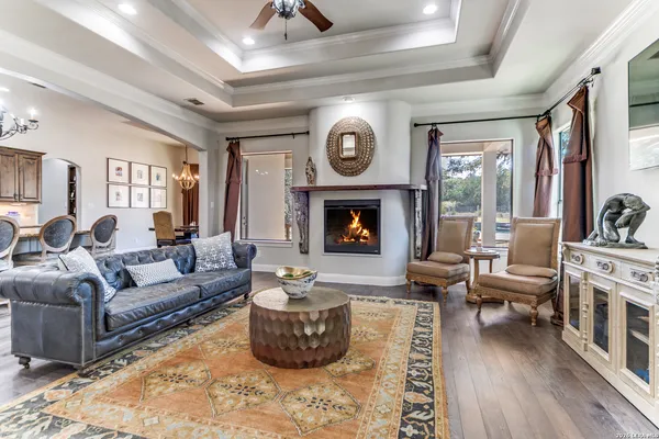 a living room with furniture a flat screen tv and a fireplace