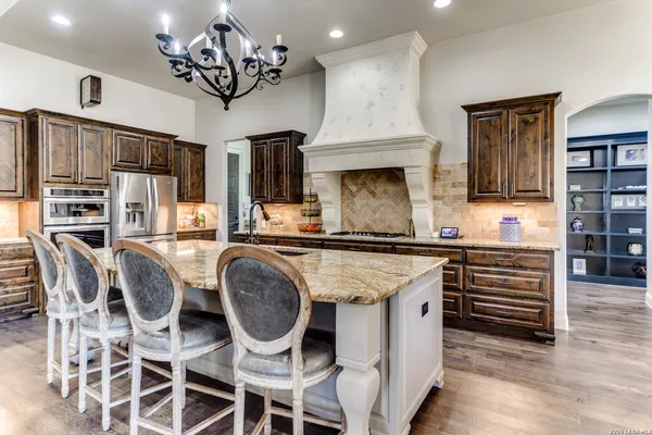a kitchen that has cabinets a sink stainless steel appliances and a counter top space