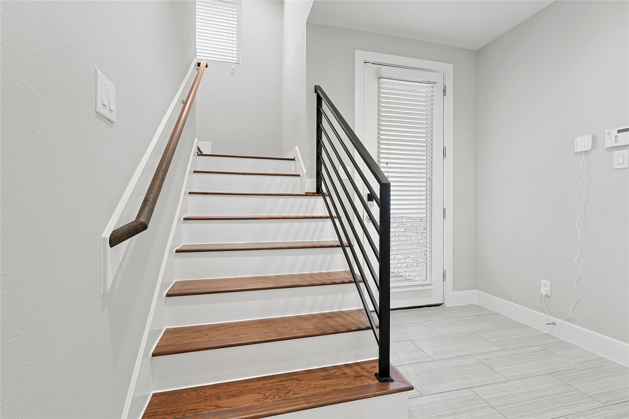 1222 Upton Street Houston, TX 77020 - Photo 9 of 41 warm wood steps paired with modern metal railing
