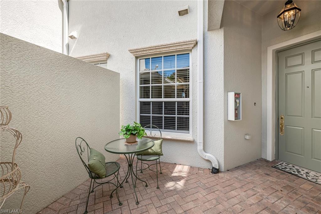 9243 Tesoro Lane, Unit 103 Naples, FL 34114 - Photo 11 of 18 a view of a room that has a table and chair in it