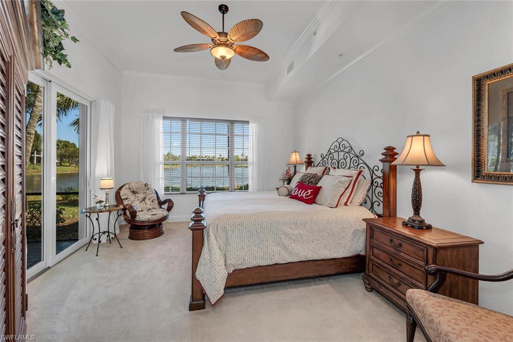 9243 Tesoro Lane, Unit 103 Naples, FL 34114 - Photo 17 of 18 a bedroom with a bed and a chandelier