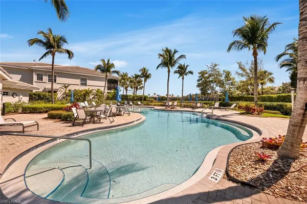 a view of a swimming pool with a table and chairs