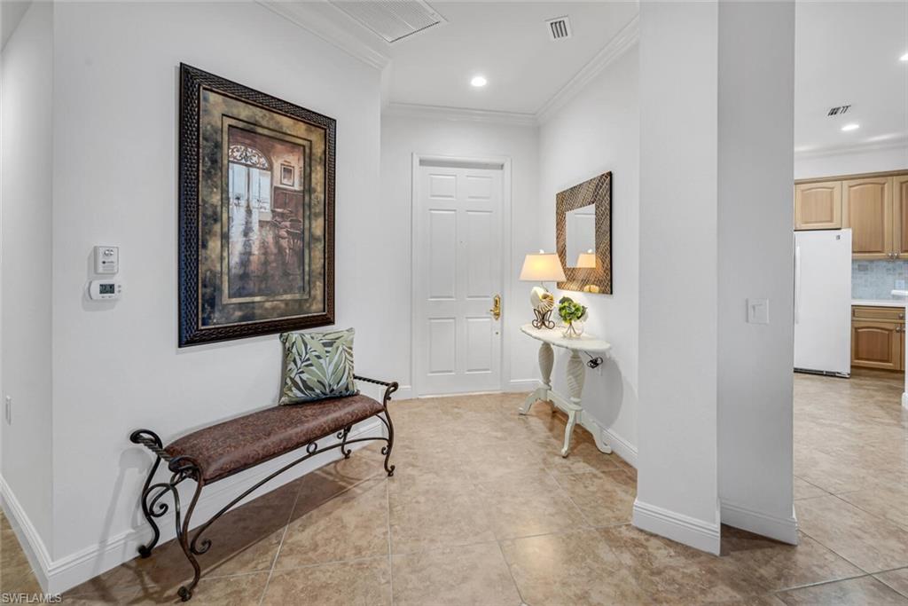 9243 Tesoro Lane, Unit 103 Naples, FL 34114 - Photo 4 of 18 a living room with furniture and a chair