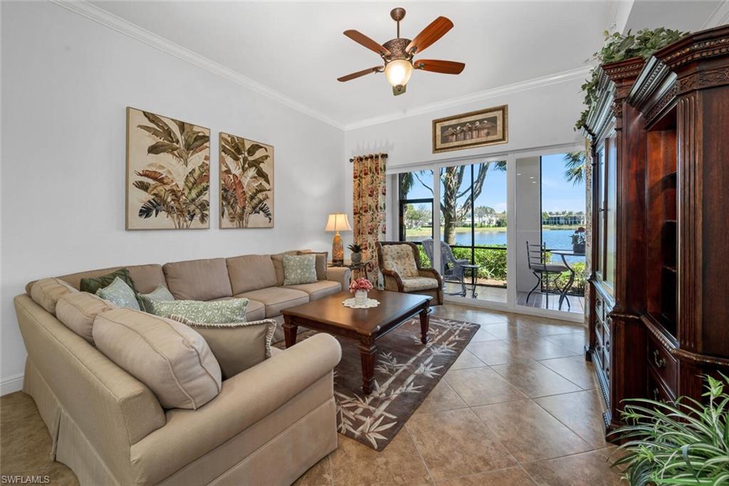 9243 Tesoro Lane, Unit 103 Naples, FL 34114 - Photo 5 of 18 a living room with furniture ceiling fan and a window