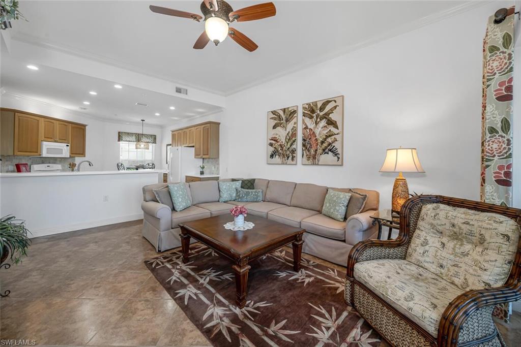 9243 Tesoro Lane, Unit 103 Naples, FL 34114 - Photo 6 of 18 a living room with furniture and a wooden floor