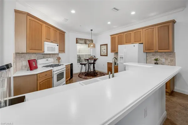 a kitchen with stove cabinets and refrigerator