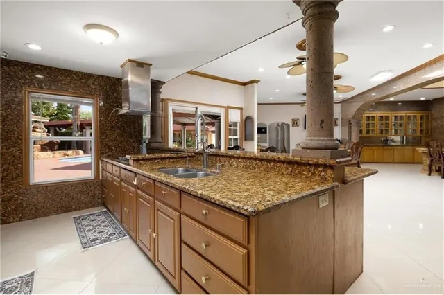 a kitchen with stainless steel appliances granite countertop a sink and a stove