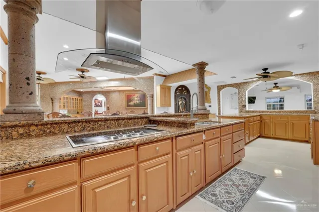 a kitchen with stainless steel appliances granite countertop a sink and cabinets