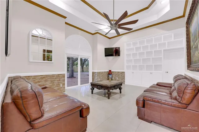 a living room with furniture and a chandelier