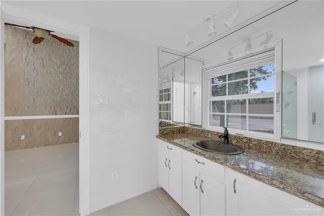a kitchen with granite countertop a sink and a window