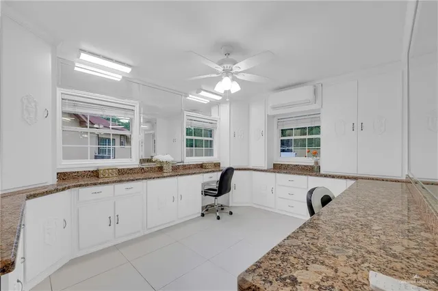 a large white bathroom with a large tub sink and window