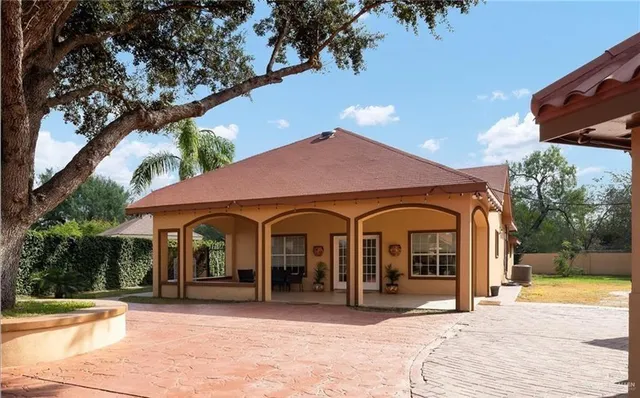 a view of a house with garden and sitting area