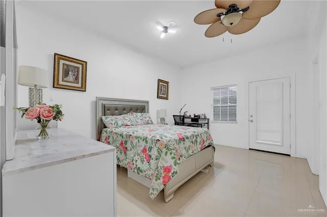 a bedroom with a bed and ceiling fan