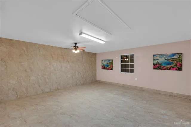 an empty room with windows and cabinet