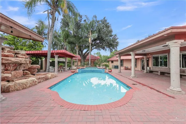 a view of a swimming pool with sitting area