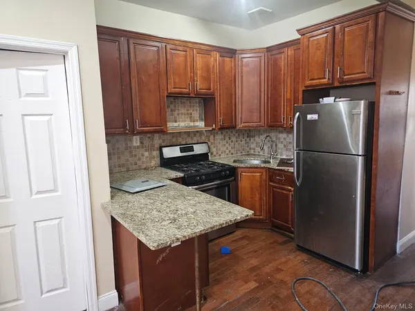 a kitchen with a refrigerator a stove a sink and a cabinets