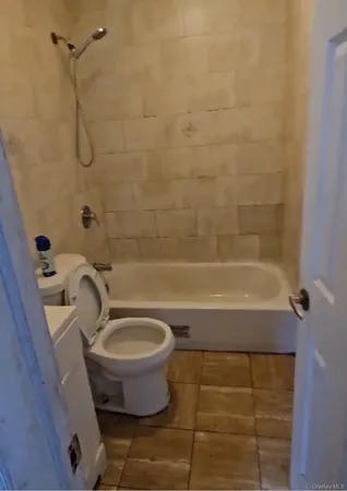 a bathroom with a toilet and a bathtub