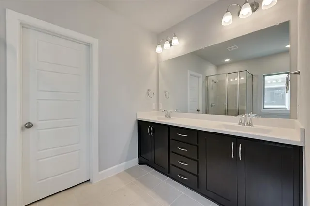 a bathroom with a double vanity sink and a mirror