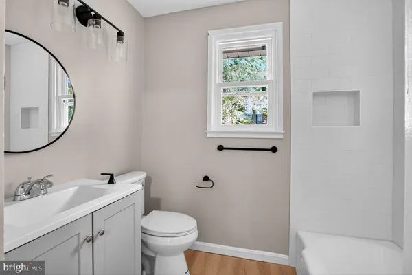 a bathroom with a sink toilet and a mirror