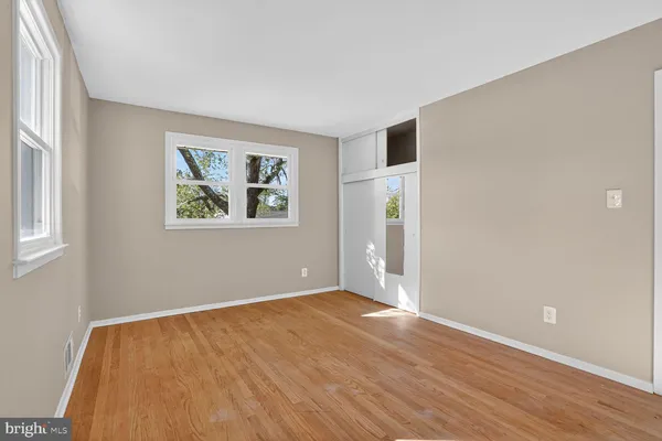 wooden floor in an empty room with a window