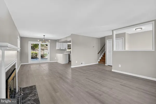 wooden floor in an empty room with a fireplace