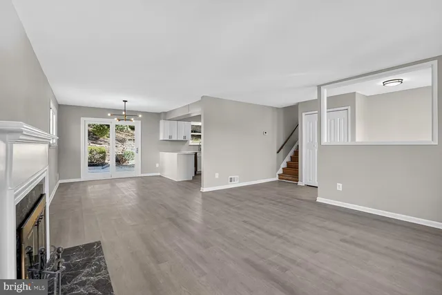 wooden floor in an empty room with a fireplace